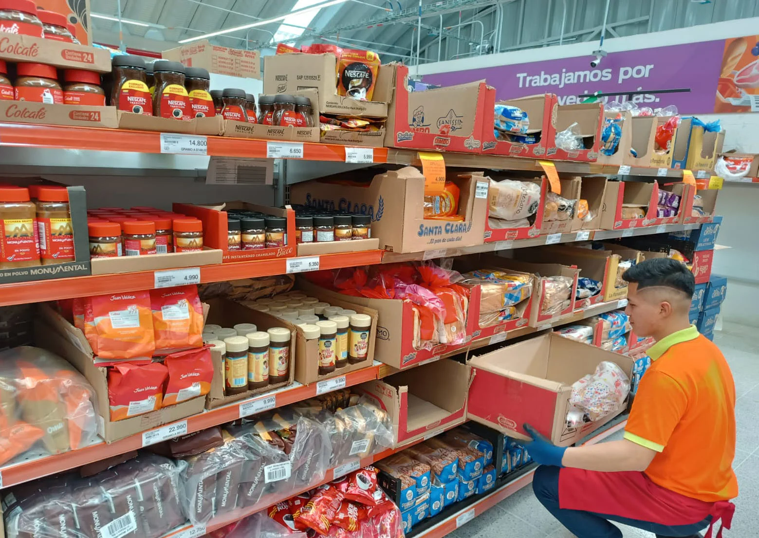 Jugendlicher füllt Regale im Supermarkt