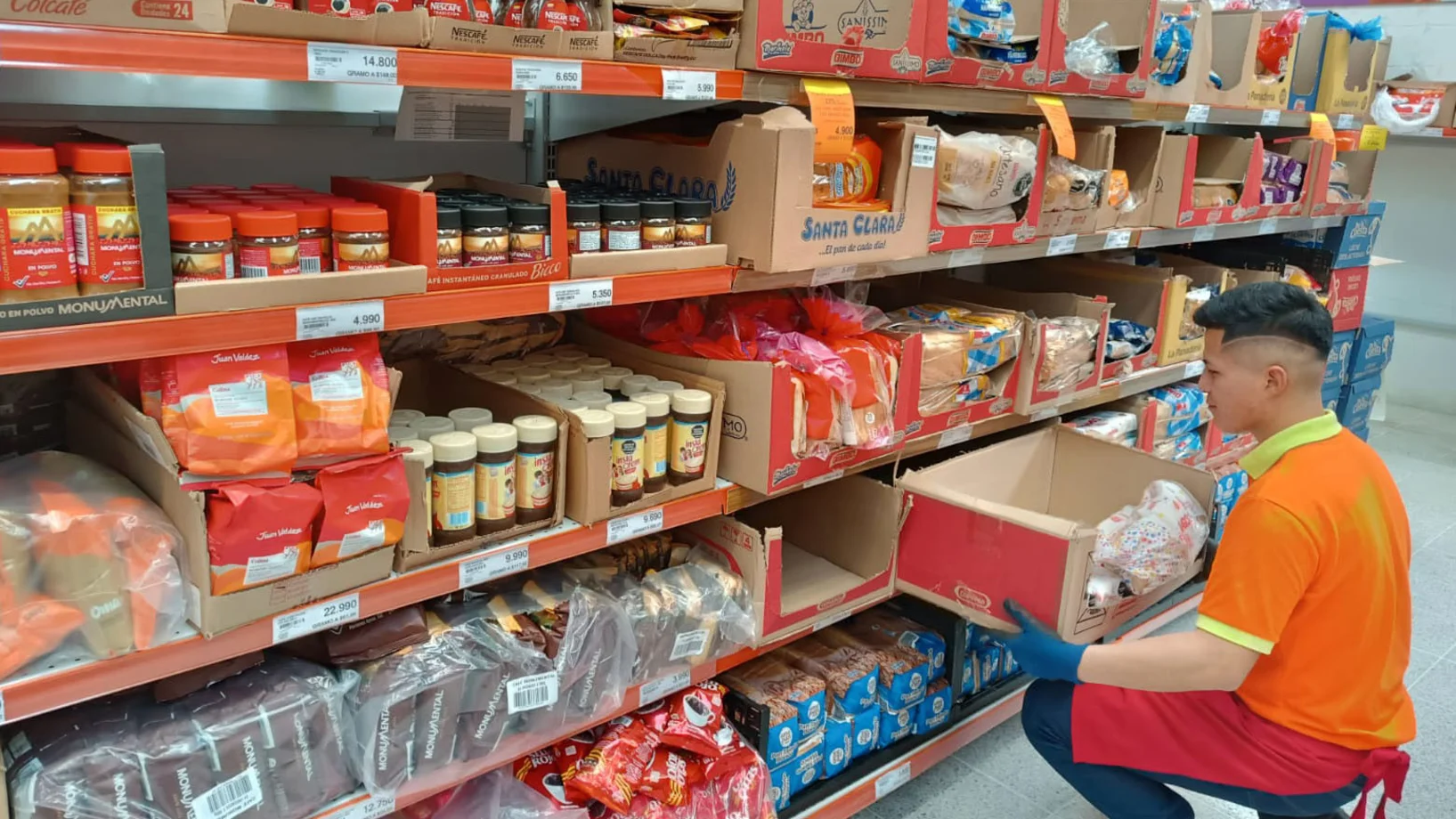 Jugendlicher füllt Regale im Supermarkt